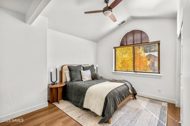 a bedroom with a bed and window