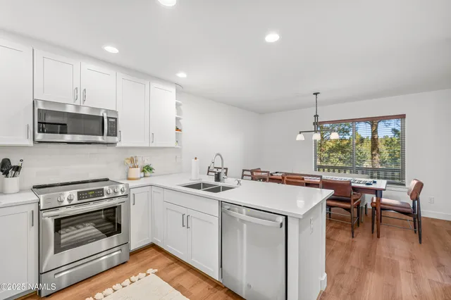 a kitchen with a stove a sink and a microwave