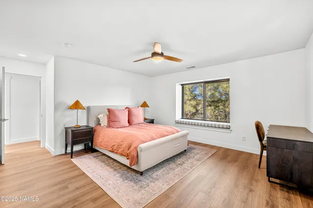 a bedroom with a bed a window and dresser