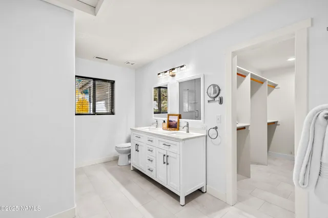 a bathroom with a double vanity sink and a mirror