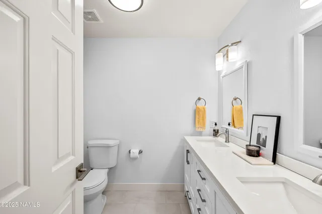 a bathroom with a sink toilet and a mirror