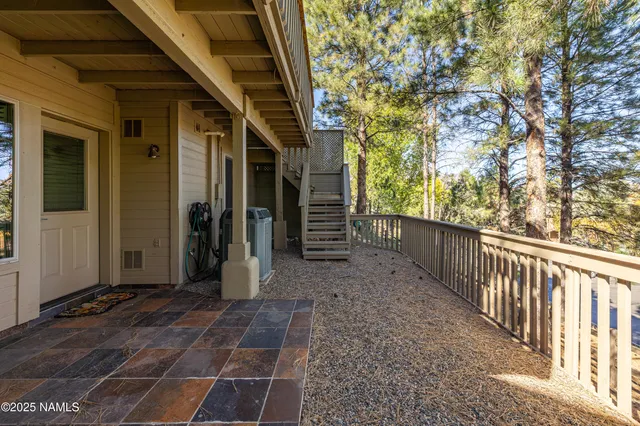 a view of a porch with wooden floor and fence