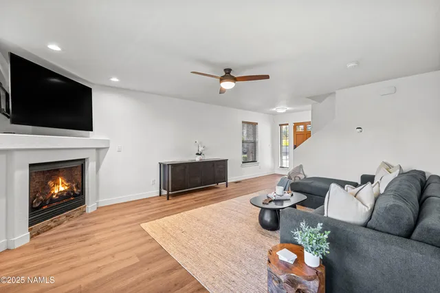 a living room with furniture a fireplace and a flat screen tv