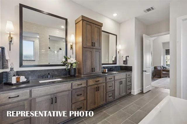 a kitchen with stainless steel appliances kitchen island granite countertop a stove refrigerator and cabinets