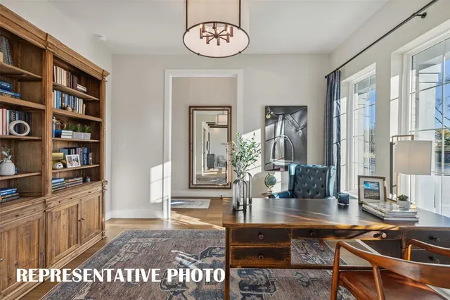 a kitchen with stainless steel appliances granite countertop a sink a stove a dining table and chairs