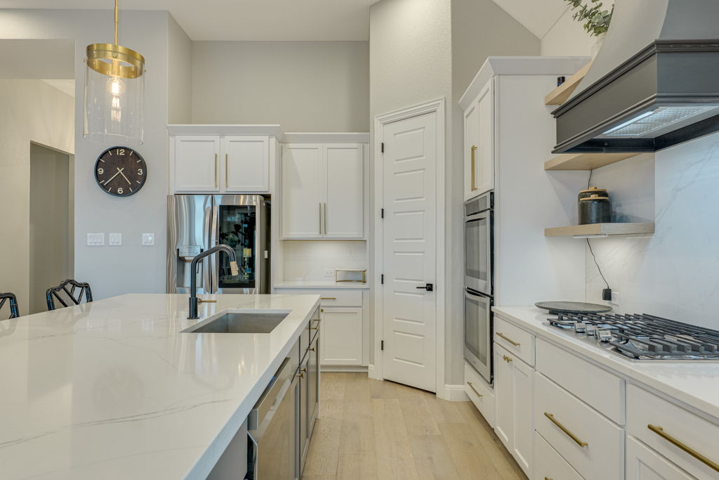 4209 Brean Down Road Pflugerville, TX 78660 - Photo 6 of 31 A well-appointed kitchen showcasing pristine countertops, a large island with a sink, and integrated stainless steel appliances.