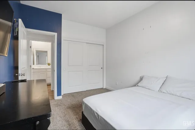 a bedroom with a bed and mirror