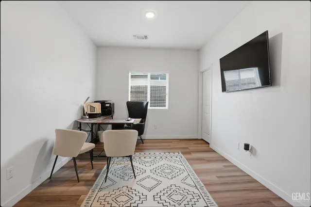a workspace with furniture hardwood and a window