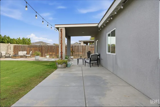 a view of a porch with a table and chairs