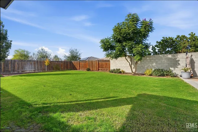a view of yard with swimming pool and green space