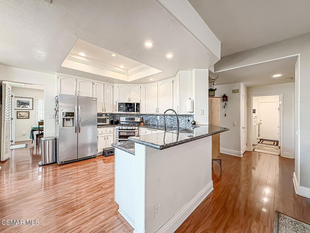 7204 University Drive Moorpark, CA 93021 - Photo 15 of 57 a kitchen with stainless steel appliances granite countertop a refrigerator and a stove top oven
