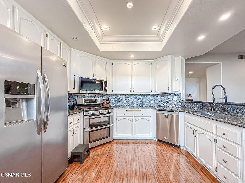 7204 University Drive Moorpark, CA 93021 - Photo 16 of 57 a kitchen with granite countertop a sink stainless steel appliances and cabinets