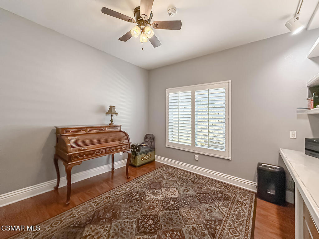 7204 University Drive Moorpark, CA 93021 - Photo 20 of 57 a living room with a piano and a printer next to a window