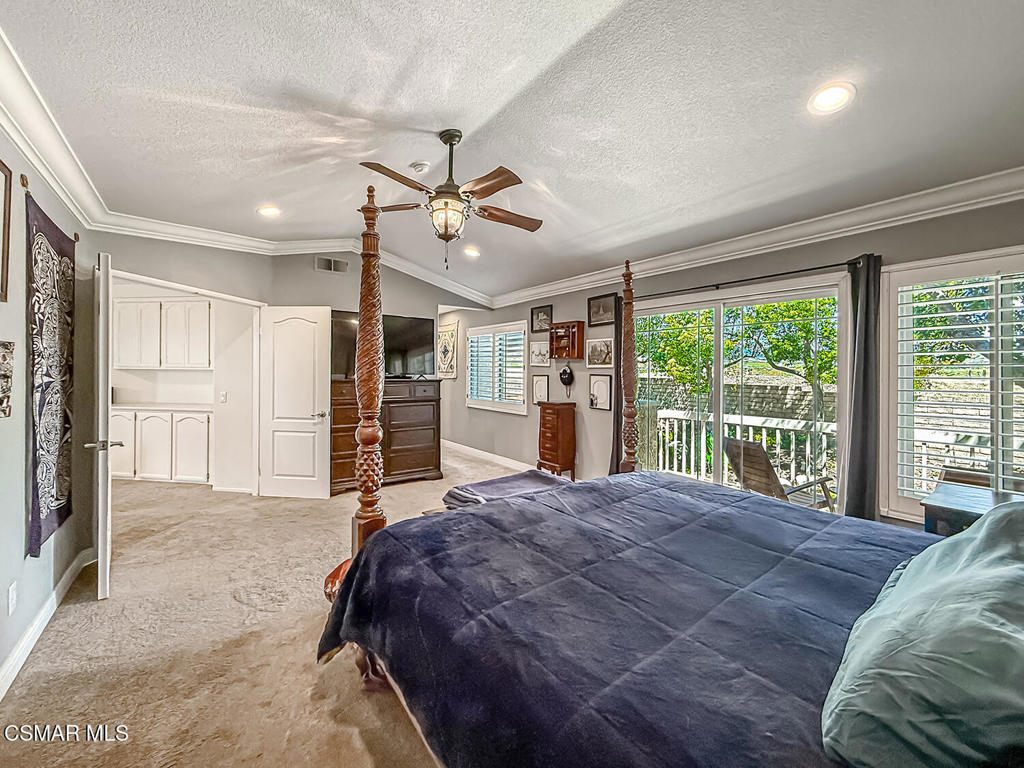 7204 University Drive Moorpark, CA 93021 - Photo 27 of 57 a spacious bedroom with a large bed closet and flat screen tv