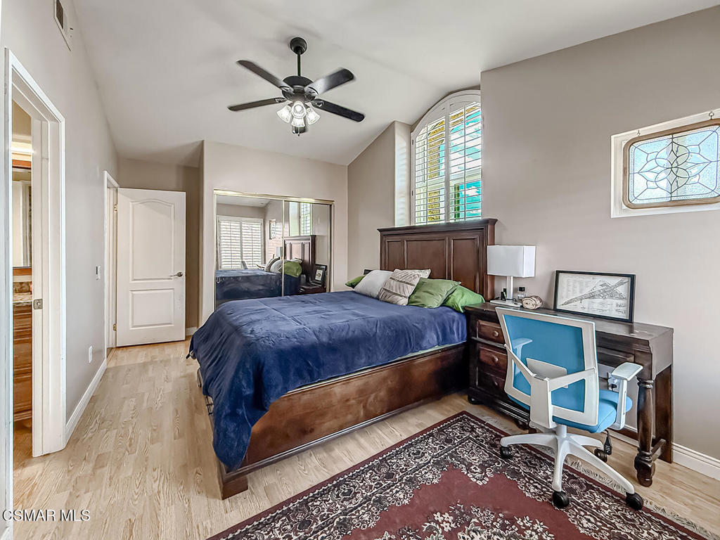 7204 University Drive Moorpark, CA 93021 - Photo 38 of 57 a bedroom with a large bed and a chandelier