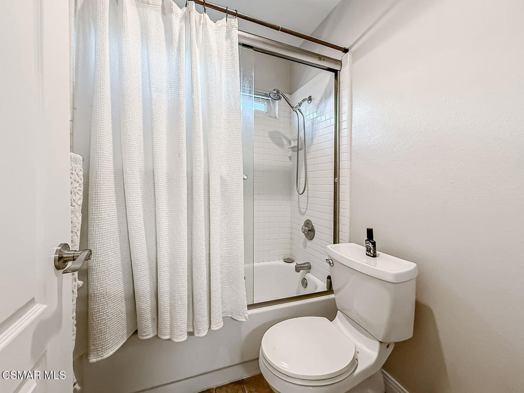 7204 University Drive Moorpark, CA 93021 - Photo 40 of 57 a white toilet sitting next to a bathroom sink