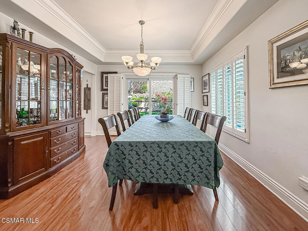 7204 University Drive Moorpark, CA 93021 - Photo 10 of 57 a view of a dining room with furniture a chandelier and wooden floor