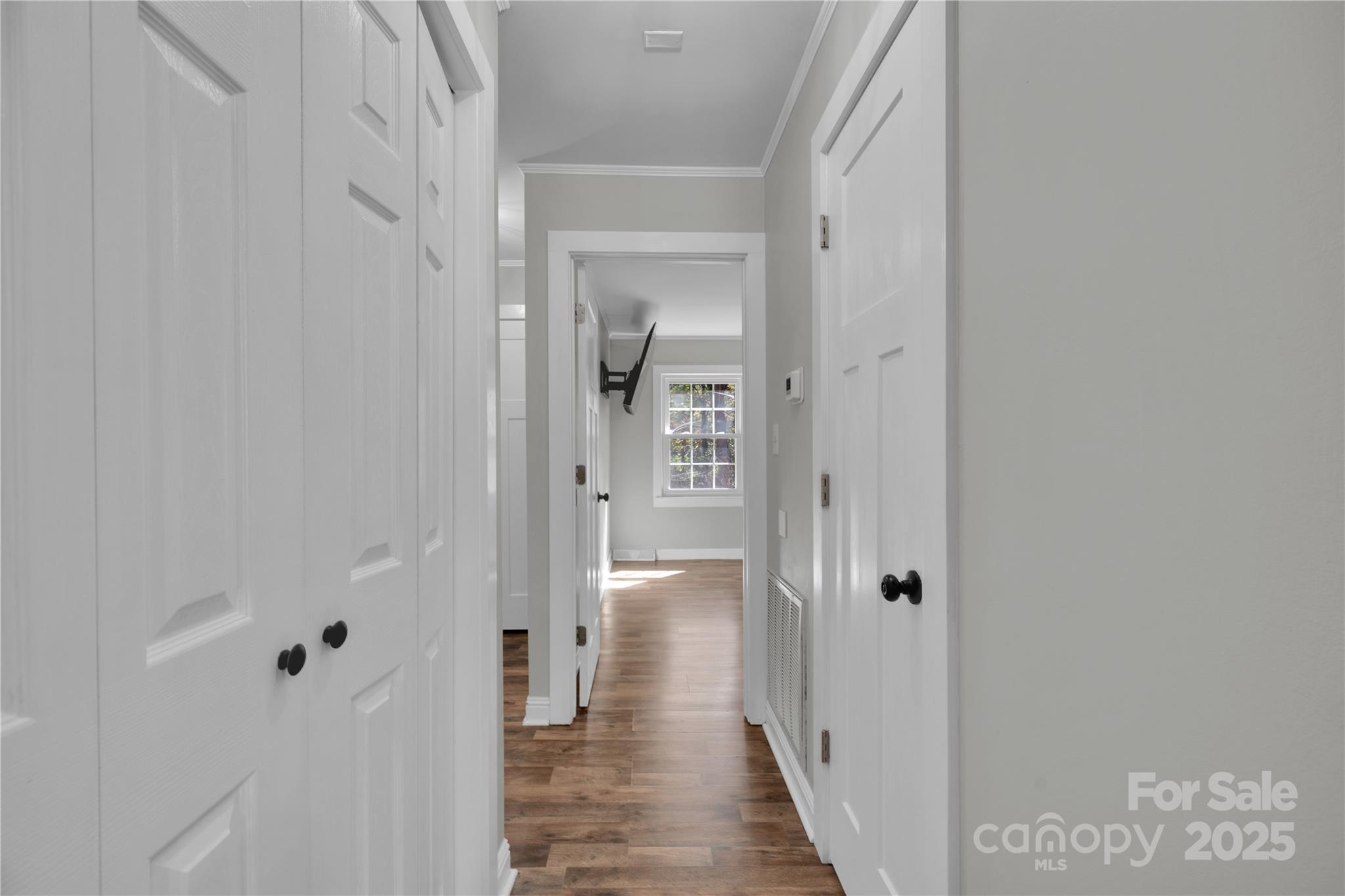 4612 Huggins Road Marshville, NC 28103 - Photo 9 of 37 a view of a hallway with wooden floor and a bathroom