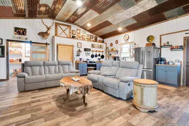 a living room with furniture and a chandelier