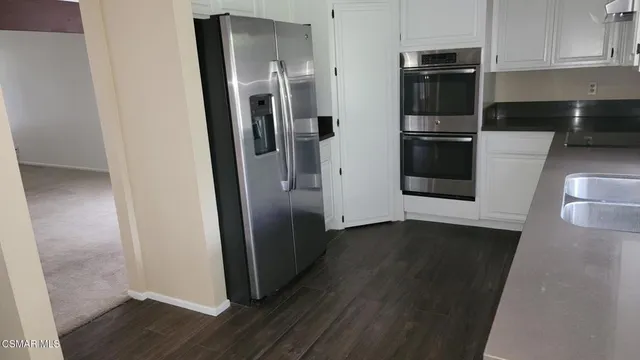 a kitchen with a sink and white cabinets