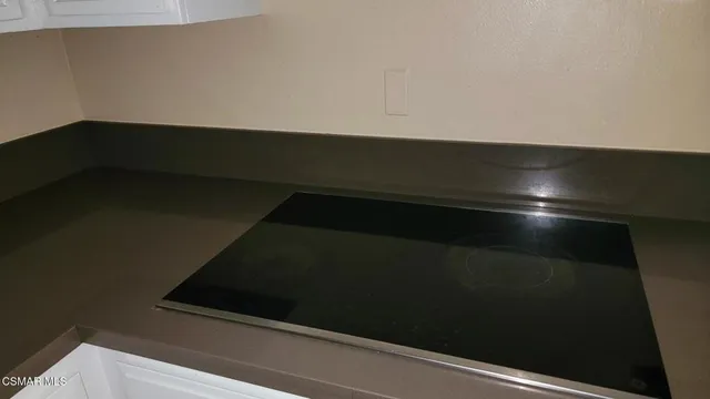 an empty room with wooden floor and fireplace