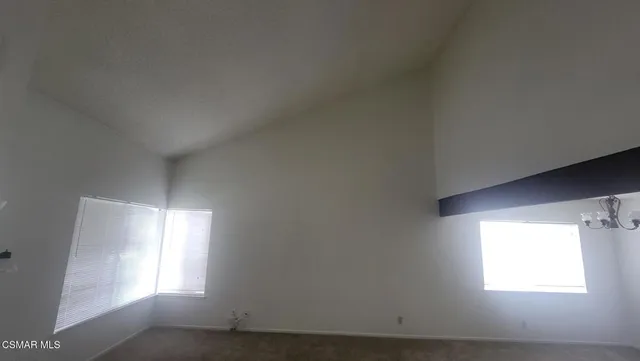 a view of a livingroom with wooden floor and a fireplace