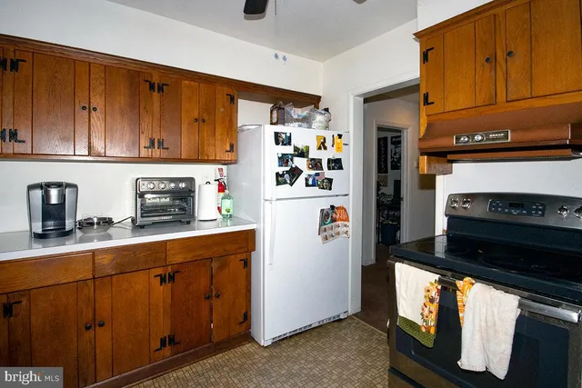 a kitchen with stainless steel appliances granite countertop a refrigerator stove and sink
