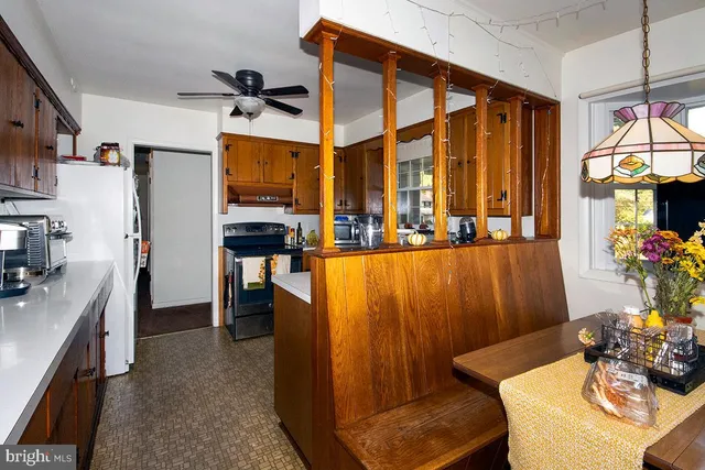 a dining room with furniture and a large window