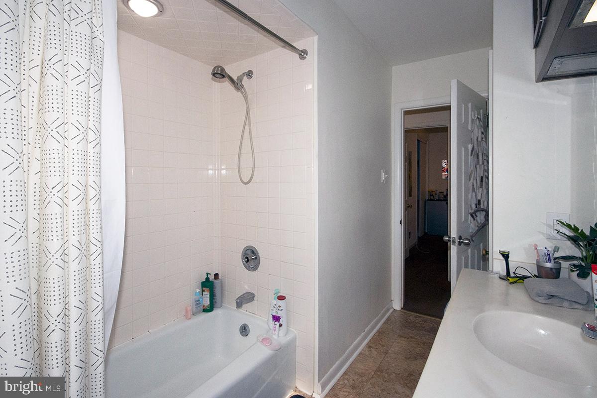 412 Swarthmore Road Glassboro, NJ 08028 - Photo 16 of 50 a bathroom with a tub a sink and a shower