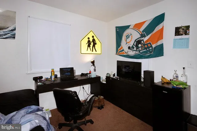 a work room with furniture and painting on the wall