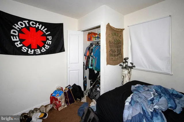 a bedroom with a bed and a wall painting