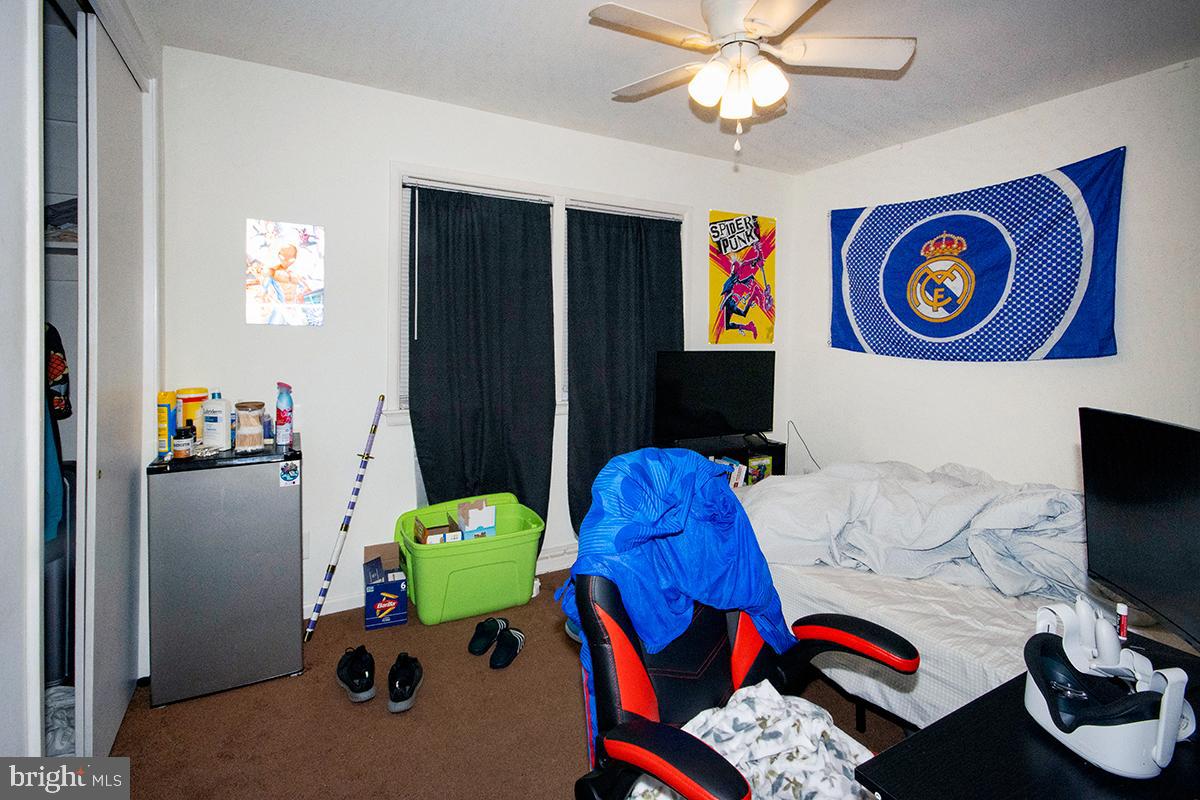 412 Swarthmore Road Glassboro, NJ 08028 - Photo 21 of 50 a bedroom with a bed and a chandelier