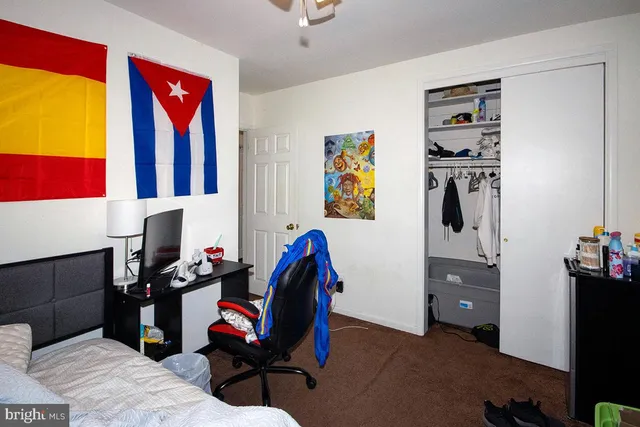 a living room with furniture and wall paintings