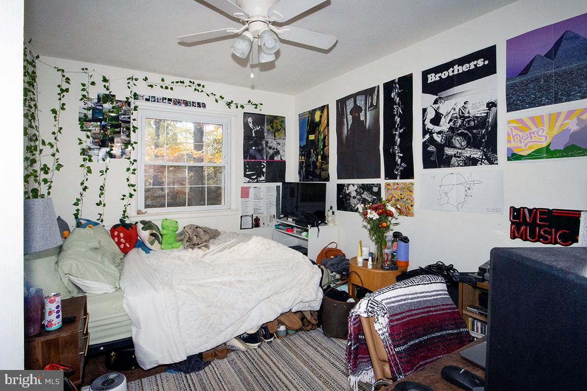 412 Swarthmore Road Glassboro, NJ 08028 - Photo 30 of 50 a living room with furniture a chandelier and a flat screen tv
