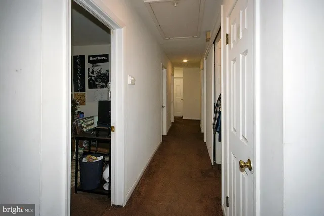 a view of a hallway with a wooden door