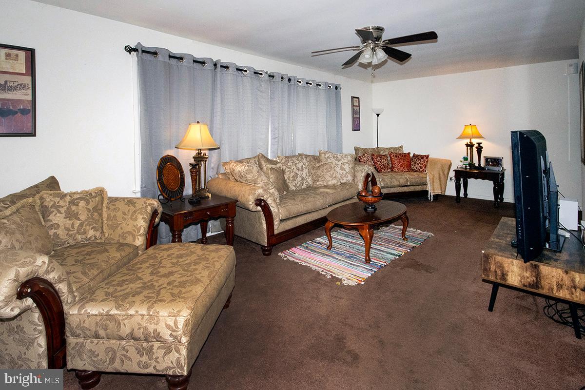 412 Swarthmore Road Glassboro, NJ 08028 - Photo 43 of 50 a living room with furniture and a rug