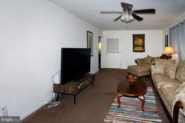 a view of a room with furniture and a window