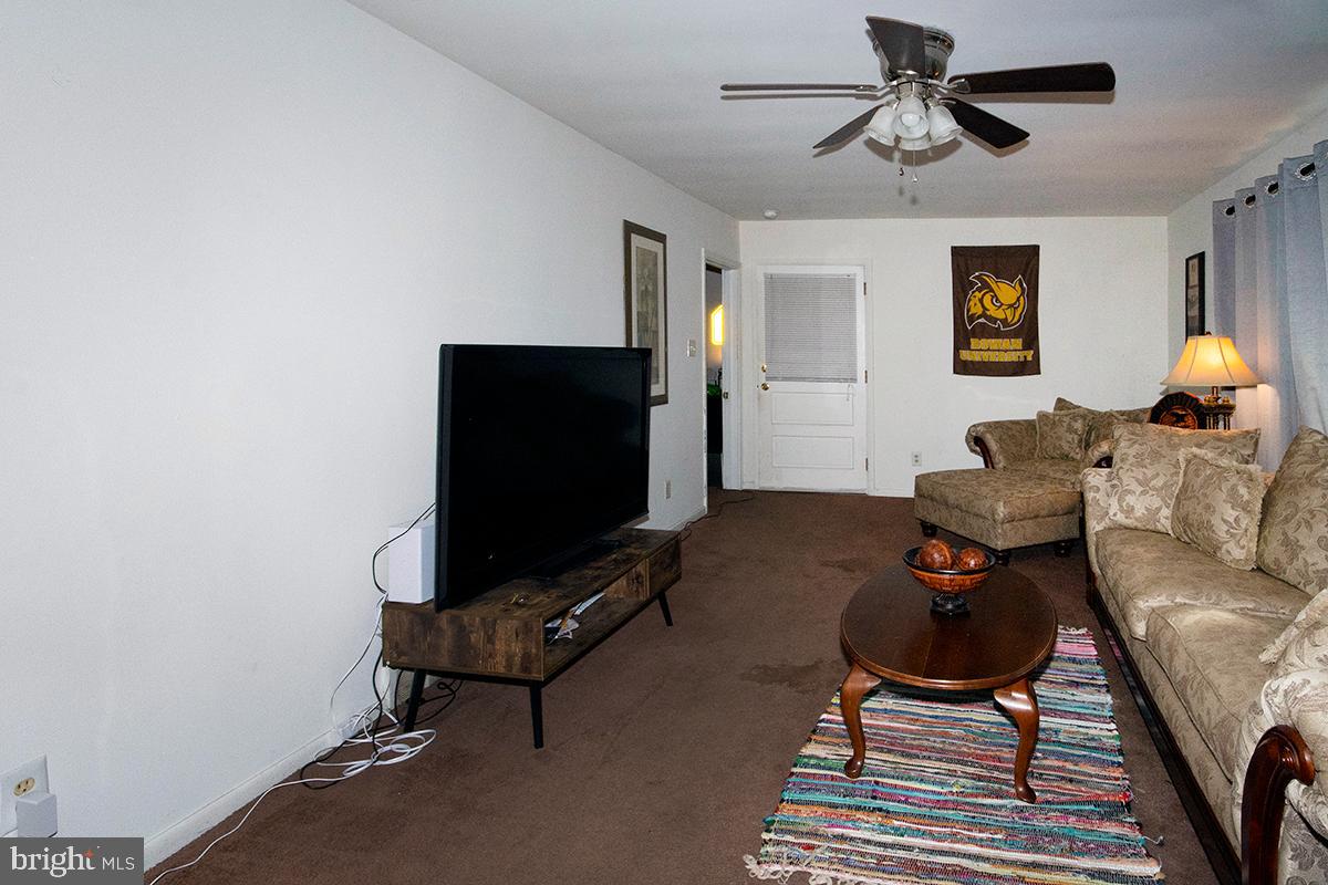 412 Swarthmore Road Glassboro, NJ 08028 - Photo 45 of 50 a living room with furniture and a flat screen tv