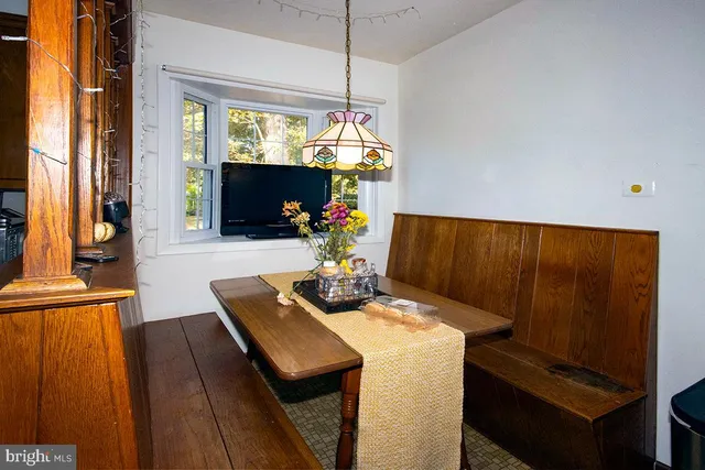 a dining room with furniture and window