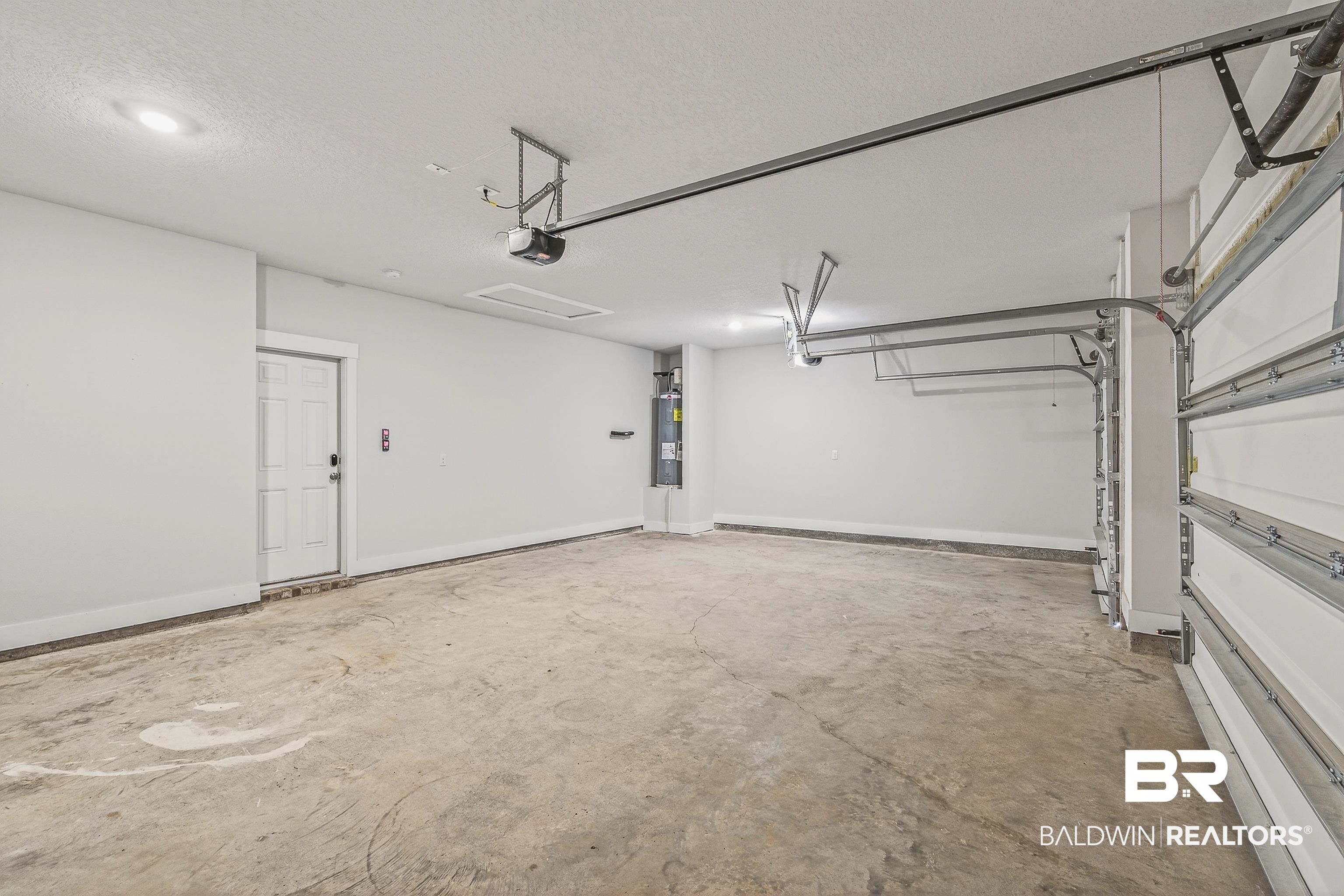 1728 Partridge Street Foley, AL 36535 - Photo 34 of 37 Garage featuring electric water heater and baseboards