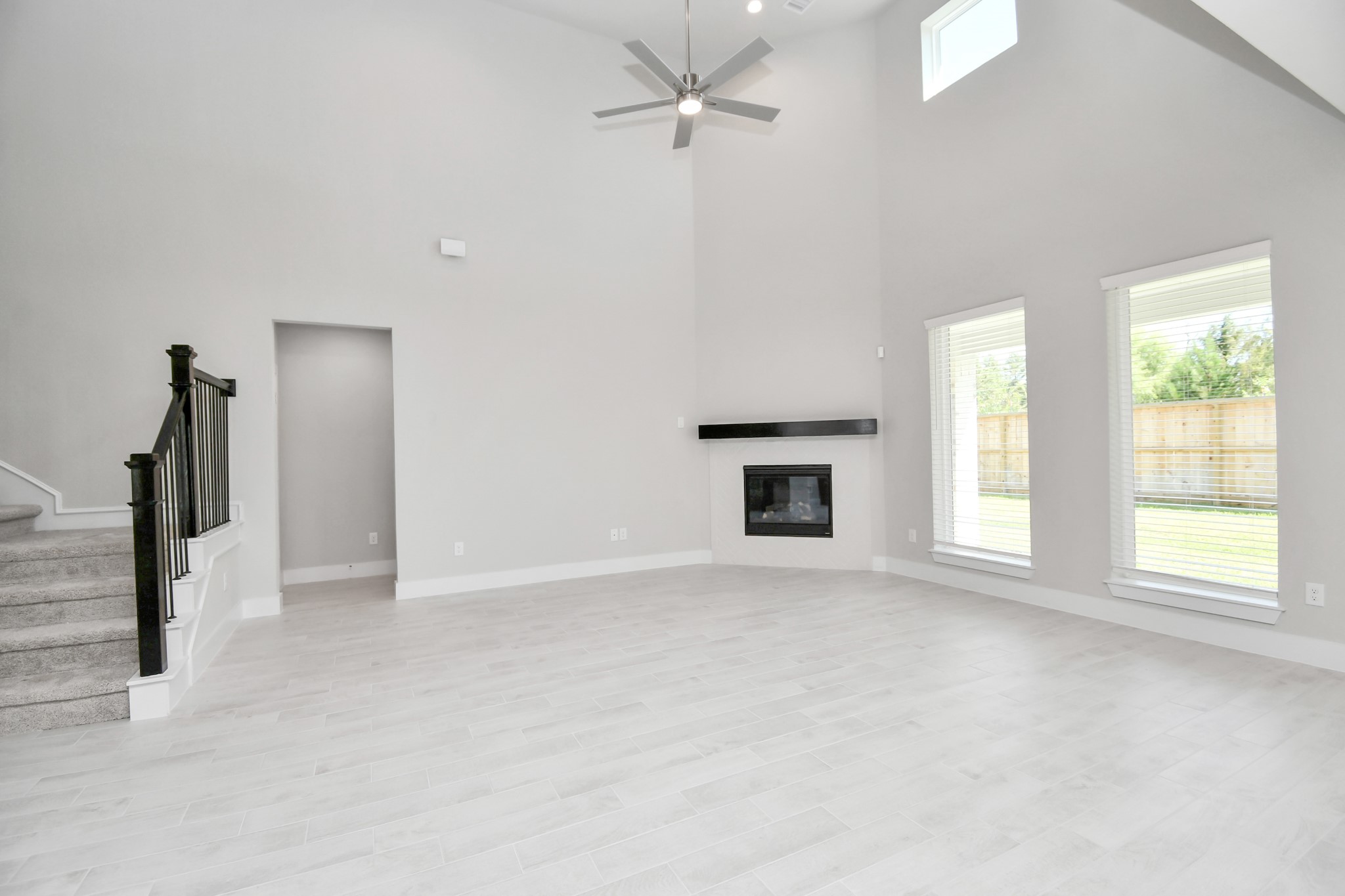 3038 Native Spg Drive Spring, TX 77373 - Photo 17 of 40 Gather the family and guests together in your lovely living room! Featuring soaring high ceilings, recessed lighting, ceiling fan, custom paint, gorgeous floors, and large windows that provide plenty of natural lighting throughout the day. Sample photo of completed home with similar floor plan. Actual colors and selections may vary.