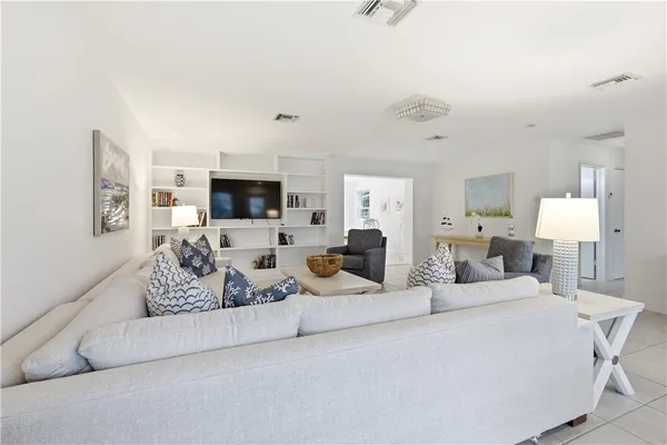a bedroom with furniture and a flat screen tv