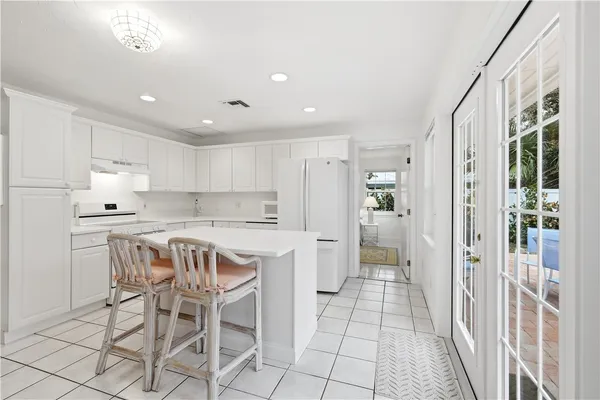a kitchen with stainless steel appliances granite countertop a refrigerator and a stove top oven