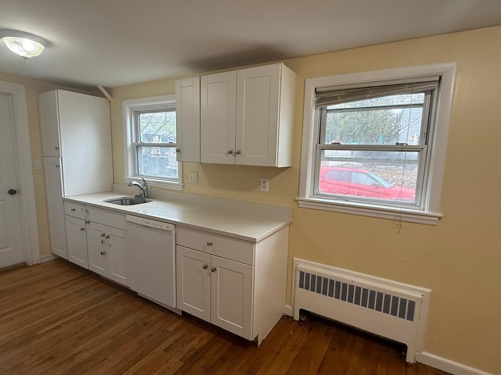 39 Alpena Avenue Dedham, MA 02026 - Photo 3 of 11 a room with cabinets and wooden floor