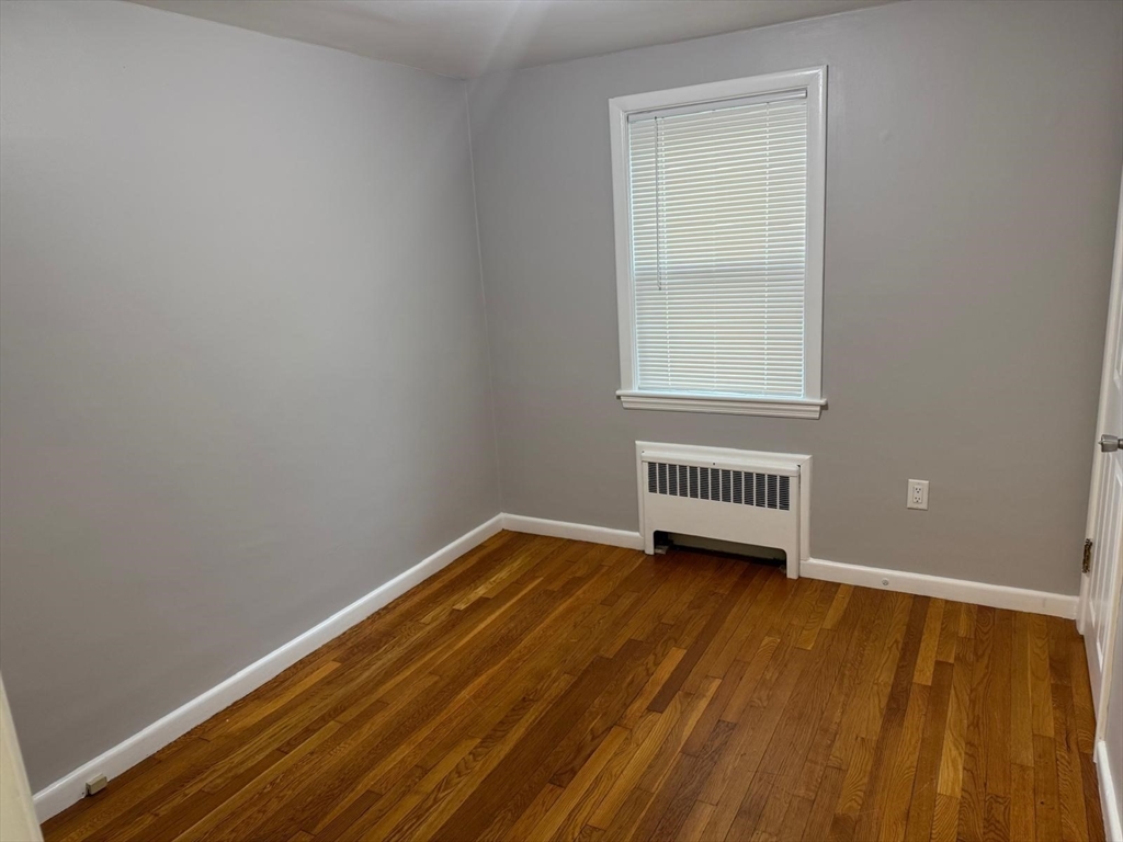 39 Alpena Avenue Dedham, MA 02026 - Photo 5 of 11 a view of a room with wooden floor and window