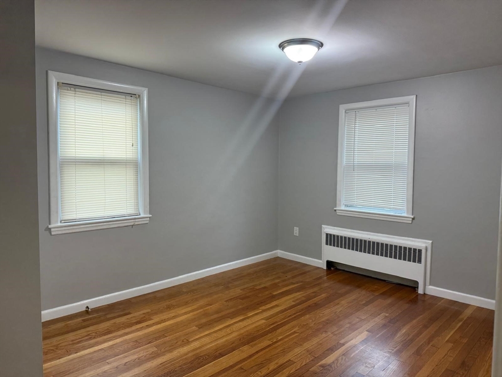 39 Alpena Avenue Dedham, MA 02026 - Photo 7 of 11 a view of room with wooden floor and fan