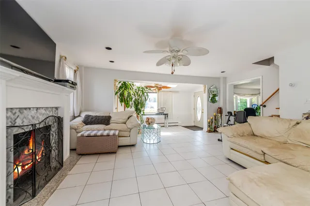 a living room with fireplace furniture and a flat screen tv