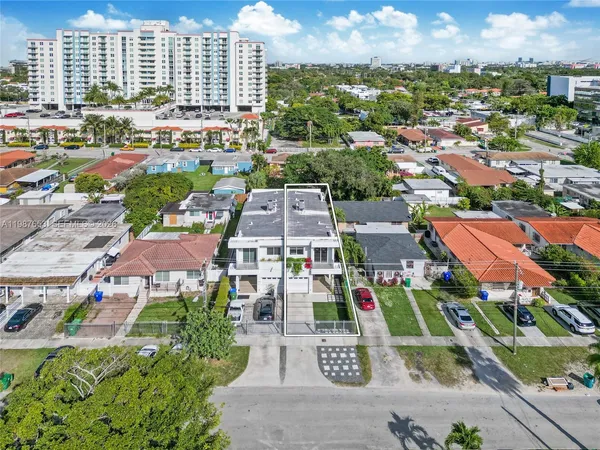 an aerial view of residential houses with outdoor space