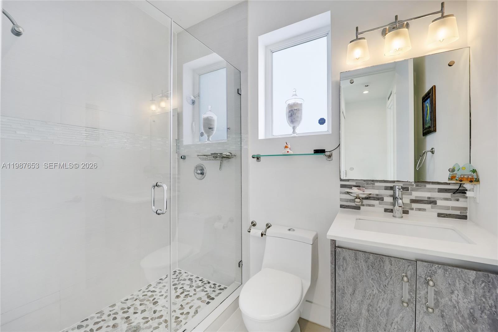 2943 Southwest 23rd Street Miami, FL 33145 - Photo 14 of 19 a bathroom with a sink a toilet and shower