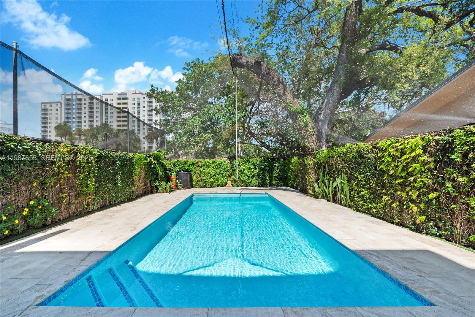2943 Southwest 23rd Street Miami, FL 33145 - Photo 3 of 19 a view of a swimming pool with a patio
